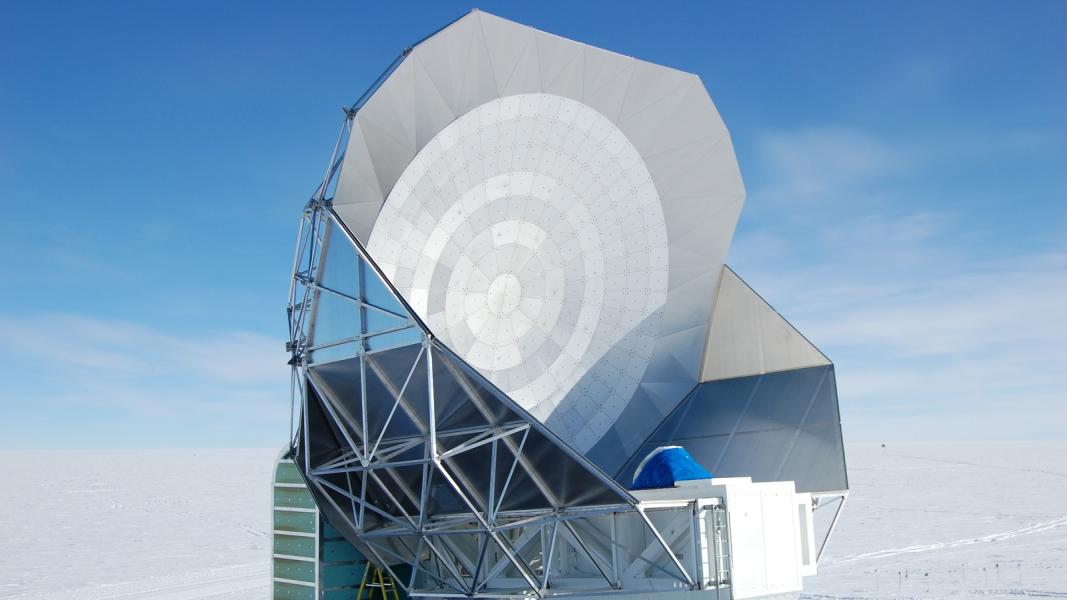 Large telescope in snowy landscape.